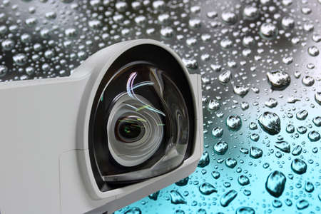 Closeup Projector big lens and background  raindrops on Tinted glassの写真素材