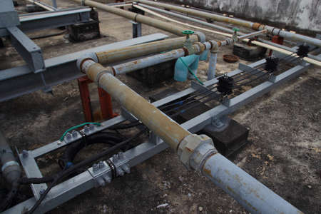 Plumbing pipes, wire on roof closeの写真素材
