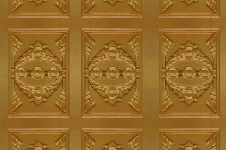 Cement gold Crafts wall in the temple close from thailandの写真素材