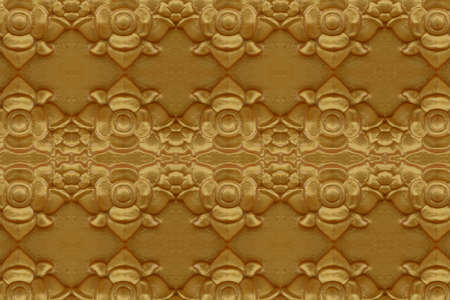 Cement gold Crafts wall in the temple close from thailandの写真素材
