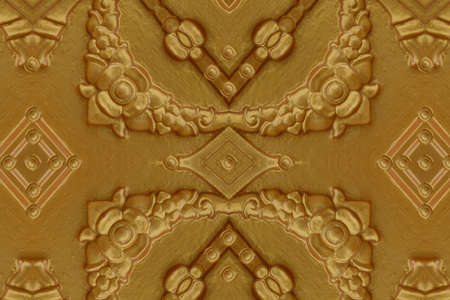 Cement gold Crafts wall in the temple close from thailandの写真素材
