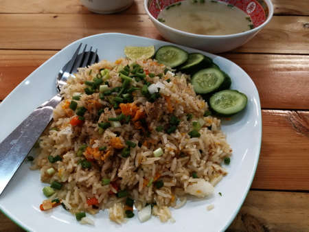 Egg fried rice in the plate on the tablewareの写真素材