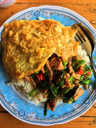 Thai style omelet with basil and pork on rice.の写真素材