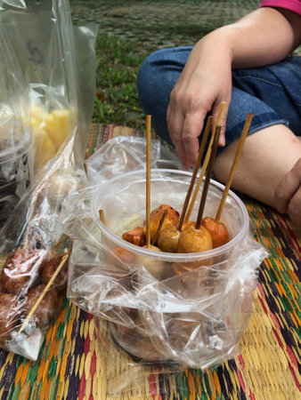 Relaxing outdoor picnic with a plate of tasty grilled meatballs.の写真素材