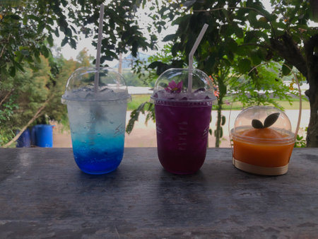 Refreshing Colorful Beverages on a Wooden Tableの写真素材