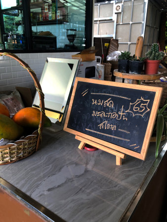 Blackboard on a table in a coffee shop with a sign for a menuの写真素材
