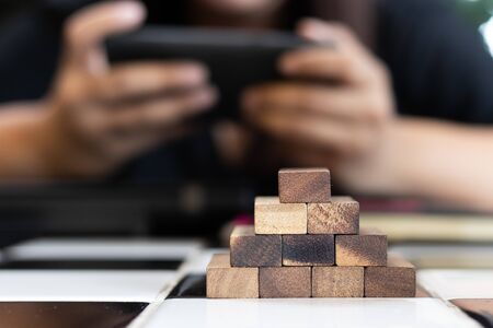 Growing business concept. Business Woman picking domino blocks for filling th