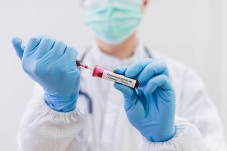 Laboratory testing patientâ€™s blood samples for presence of coronavirus (COVID-19), The doctor...