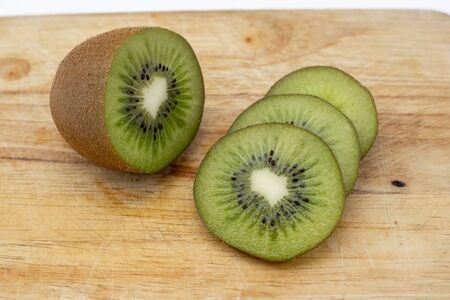 Closeup Kiwi fruit slice on the old wood butcher.の写真素材