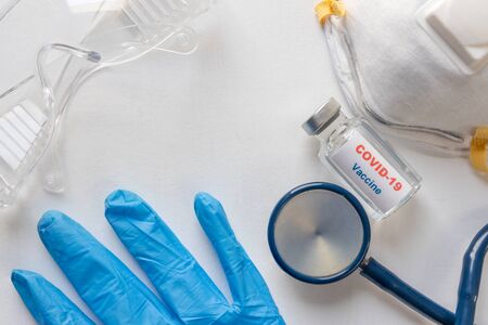 Covid-19 or coronavirus vaccine vial and syringe and Stethoscope and mask on white background. Medical conptの写真素材