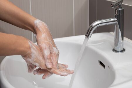 Coronavirus pandemic prevention by  wash hands and fingers with soap for frequently or using hand sanitizer gel.の写真素材