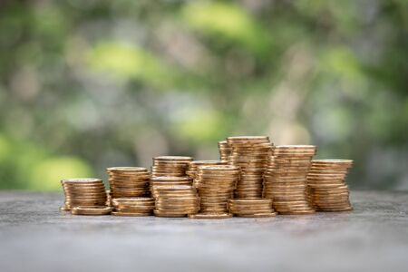 Money Financial Business Growth concept. Pile of gold coins with nature backgroundの写真素材
