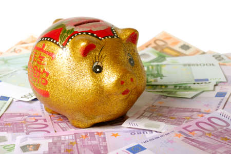 Piggy bank over bills and white backgroundの写真素材