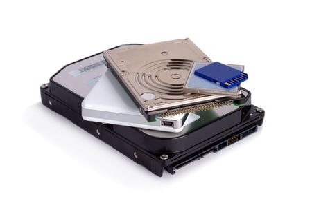 Heap of different storage devices isolated over white background
