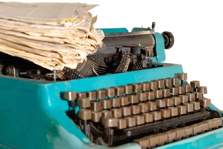 Old typewriter with stack of newspapers over white background