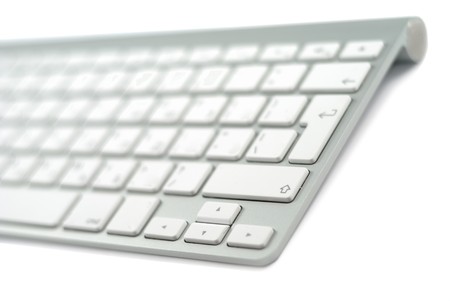 Wireless metallic keyboard isolated over white background