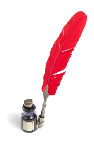 Antique glass inkwell and red feather pen isolated over white background                の写真素材