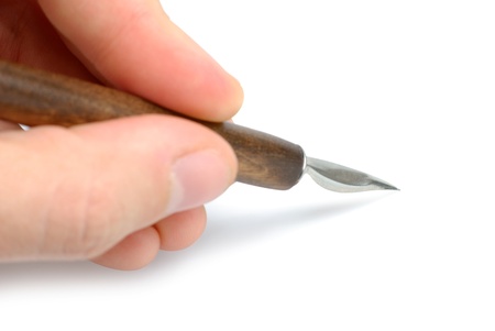 Male hand with quill isolated with clipping path over white backgroundの写真素材