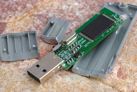 Broken flash drive on the stone floor