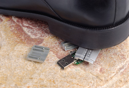 Black sole of boot on broken flash drive. Clipping path included.の写真素材