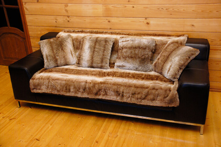 Black leather sofa with pillows and luxurious coverの写真素材
