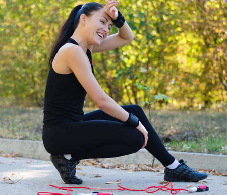 Happy young girl after excercise with a jumping rope