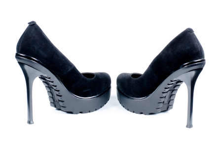 Pair of stylish black elegant ladies shoes viewed from the rear with high heels on a white backgroundの写真素材