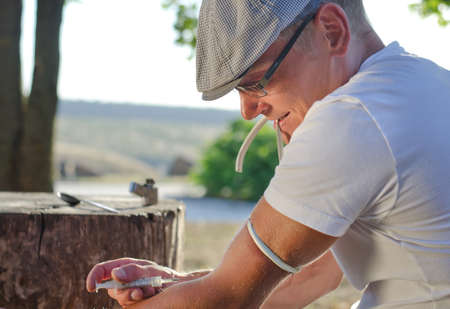 Drug user shooting up injecting himself in the veins of his arm to satisfy his addictionの写真素材