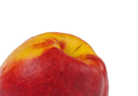 Close up of a ripe juicy orange-red nectarine isolated on a white backgroundの写真素材