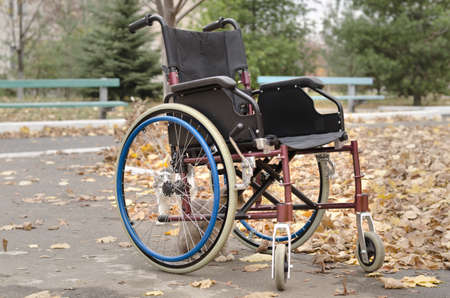 One wheelchair outdoors in a fall landscapeの写真素材