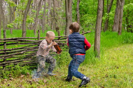 Two Young Boys Playing in the Woods.の写真素材