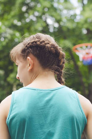 Young boy having fun playing basketball outdoors