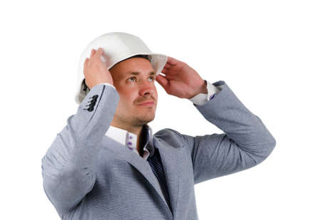 Close up Middle Age Engineer in Gray Coat and White Helmet Thinking New Ideas with Lifted Hands.の写真素材