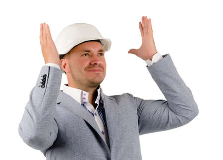 Close up Middle Age Engineer in Gray Coat and White Helmet Thinking New Ideas with Lifted Hands.の写真素材