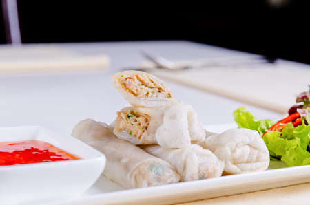 Close up Gourmet Delicious Spring Roll Recipe with Sweet Dipping Sauce on White Plateの写真素材