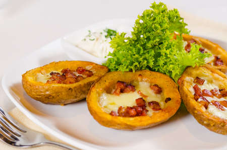 Close Up of Potato Skins with Cheese and Bacon Appetizer with Dipping Sauceの写真素材