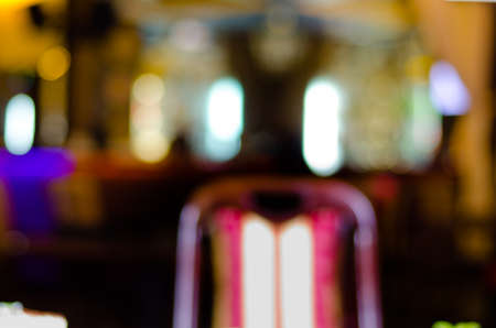 Warm yellow lights and white neon in a blurred interior of a fancy location for food and drinks as a restaurant, cafeteria or barの写真素材