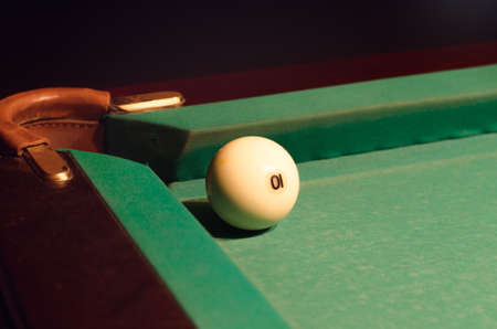 Close up White Pool Ball with Number 10 Near the Hole of the Table