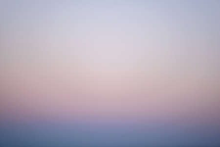 Faded blue and pink colors of a clear cloudless sky at sunset