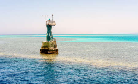 Navigation beacon for ships on a tidal sand bank in mid ocean to warn ships of the hazard and mark the edge of the deeper channelの写真素材