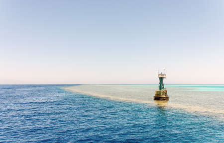 Navigation beacon for ships on a tidal sand bank in mid ocean to warn ships of the hazard and mark the edge of the deeper channelの写真素材
