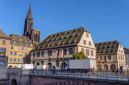 France, Strasburg 03 November 2015:Low angle view of unique church exterior with triangular steeple surrounded by bright blue skyのeditorial素材