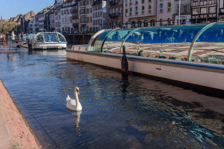 STRASBOURG, FRANCE - SEPTEMBER 26 2015: Strasbourg, water canal in Petite France area. timbered houses and trees in Grand Ile. Alsace, France. in the foreground water busのeditorial素材