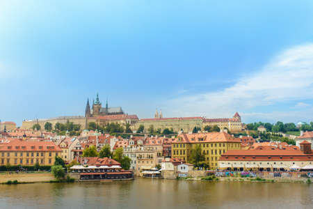Waterfront and Vitava River, Prague, Czech Republic with a scenic view of the historic architecture...