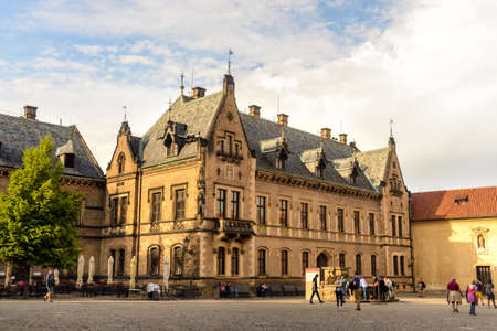 Gothic styled medieval building on street corner as people walk past on a pleasant afternoonのeditorial素材