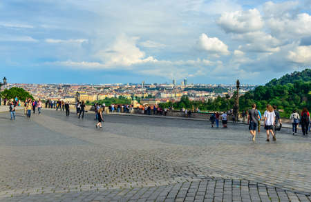 Czech Republic, Prague -28 Jule 2016:Scenic view of distant European city under billowy clouds as seen from cobblestone pedestrian boulevardのeditorial素材