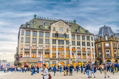Amsterdam, The Netherlands - 28 July 2016:European city with wide plaza Madame Tussauds and old building as tourist and locals traverse itのeditorial素材