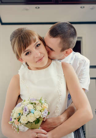 Happy newlyweds share an intimate embrace with joyful smiles , close up upper body portraitの写真素材