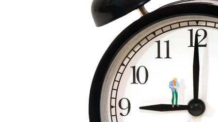 close up a young man standing on clockwise, waiting for something concept, white background with copy spaceの写真素材