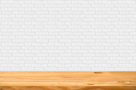 Empty wooden table over white brick background. Ready for product display montage.の写真素材